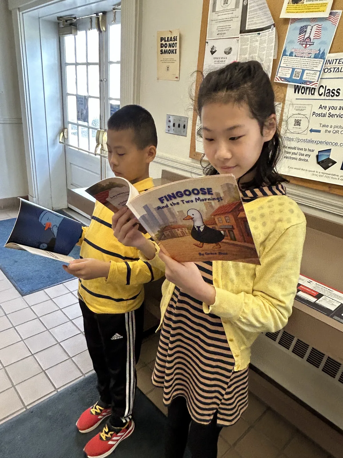 Students reading donated FinGoose books